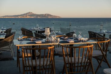 Breathtaking seaside dining setup with neatly arranged...