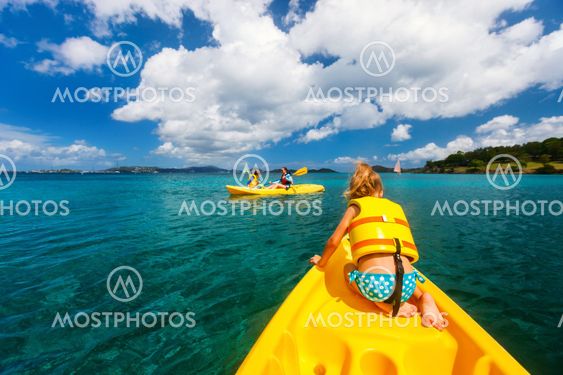 Family kayaking at tropical ocean