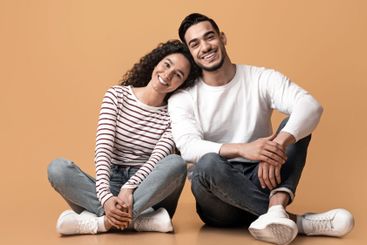 Romantic young middle eastern couple sitting on floor...