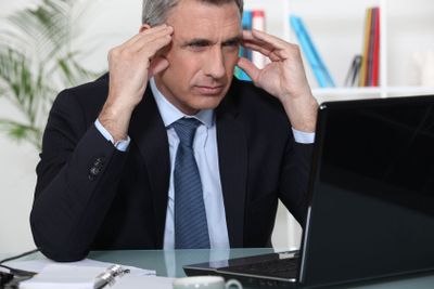 Stressed businessman sat at desk