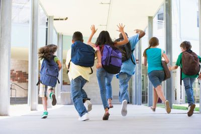Elementary school pupils running outside