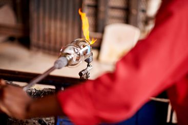 Fire, glassblowing and hands of artisan person closeup...