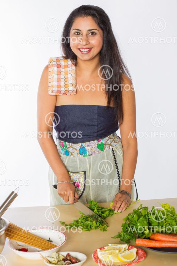 Smiling Indian Woman Cutting Herbs