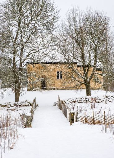 Old Swedish church from 12th century in a snowy countryside