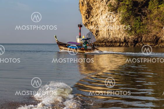 Thai traditional wooden longtail boat Limestone karst rocks