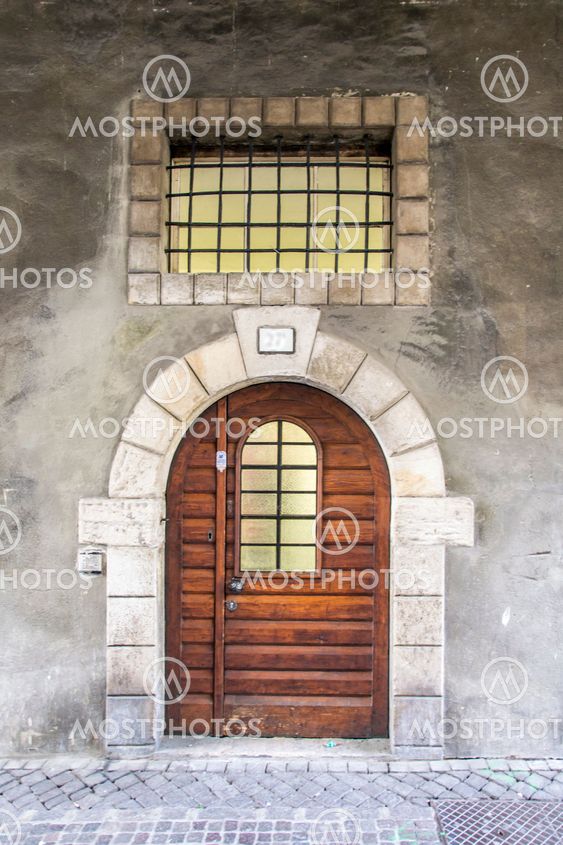 Old massive wooden door with railing