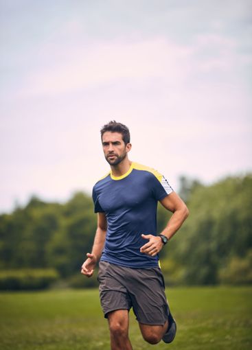 Morning, exercise and man on grass for running...