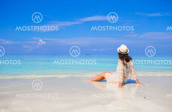 Young happy woman enjoy summer vacation on white sandy beach