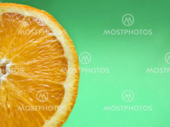 sliced orange macro on green background