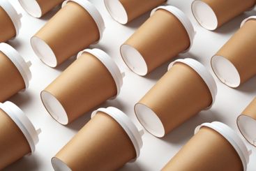 A collection of disposable paper cups arranged in a...