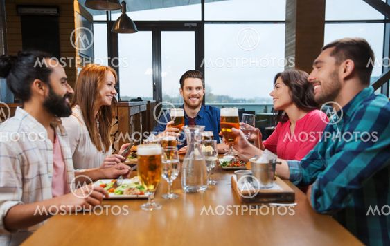 friends dining and drinking beer at restaurant