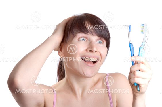 Woman with braces with toothbrushes