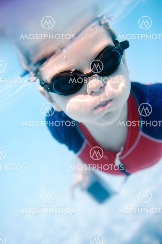 Little boy swimming underwater