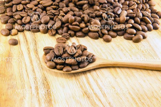 Coffee beans on vintage wooden board