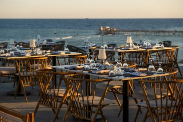 Seaside restaurant tables set for an exquisite dining...