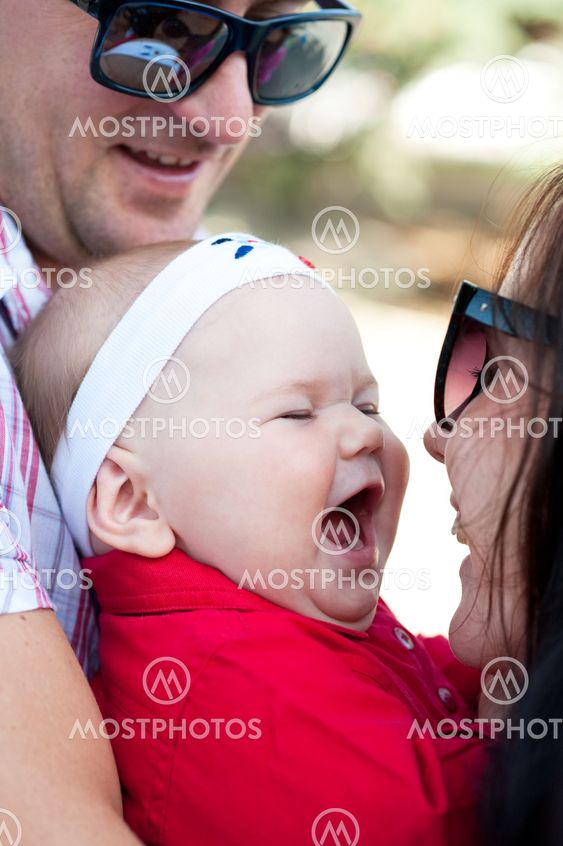 the baby in embraces of loving parents
