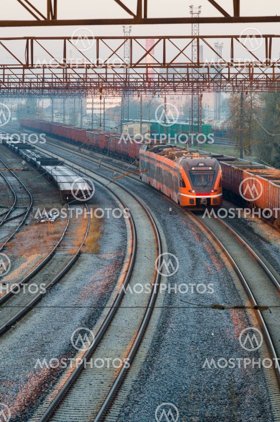 Modern electric train moving through railway station