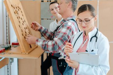 Doctor writing down results from occupational therapy...