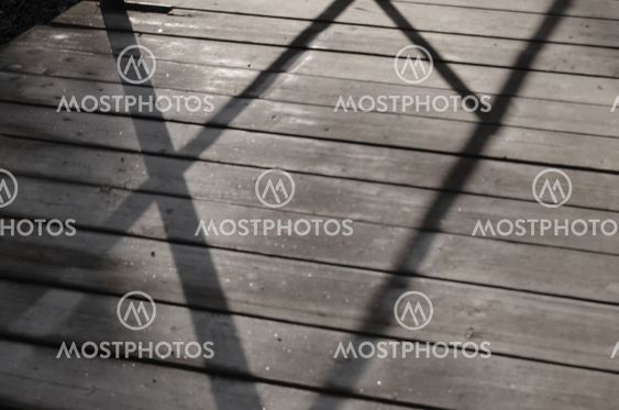 Surface icy boards with shadows from the rail