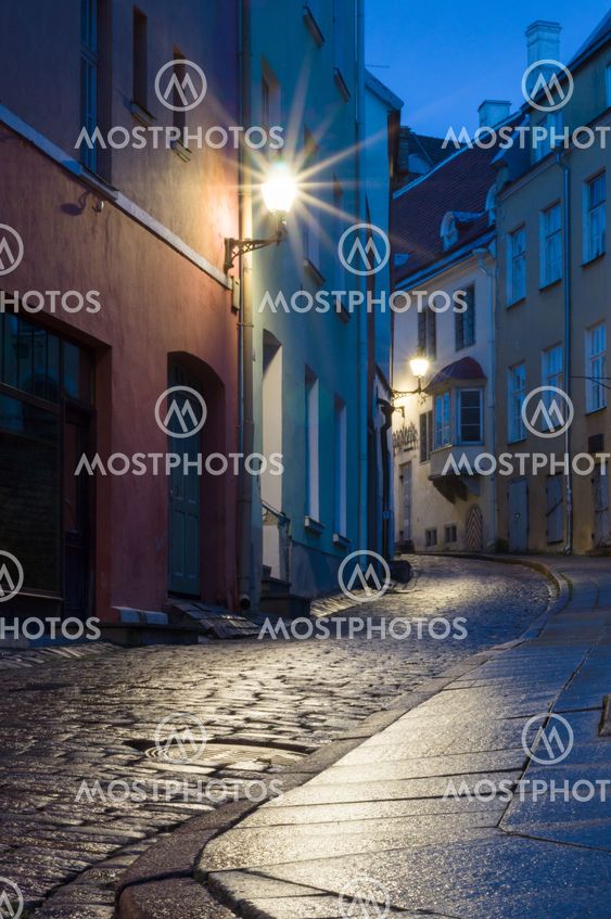 Illuminated narrow street at night in Tallinn Old Town