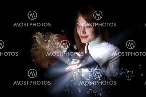 Young woman reading a magic book