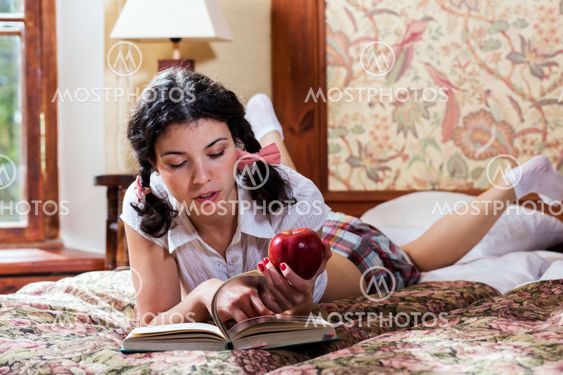 Woman in schoolgirl dress turn pages