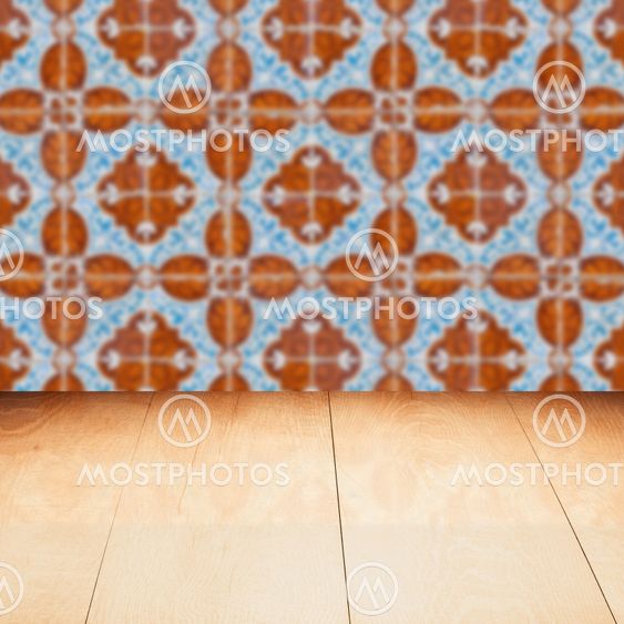 Wood table top and blur vintage ceramic tile pattern wall