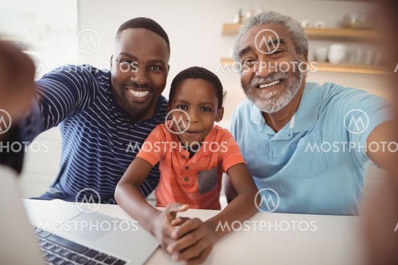 Happy multi-generation family looking at camera
