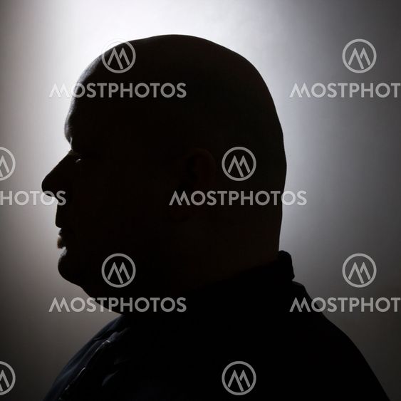 Silhouette of bald man.