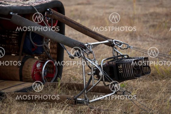 burner and wicker gondola lying on the meadow