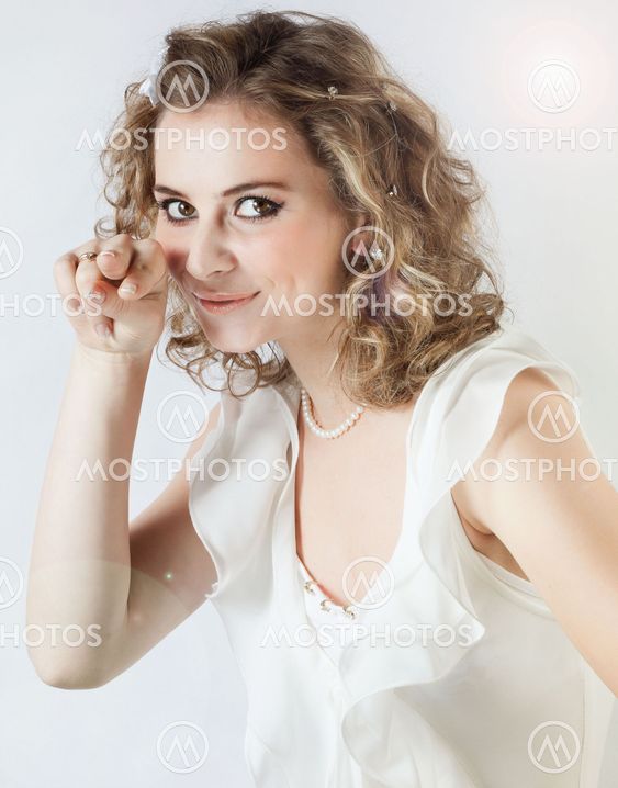 Funny young girl shows a finger at the camera