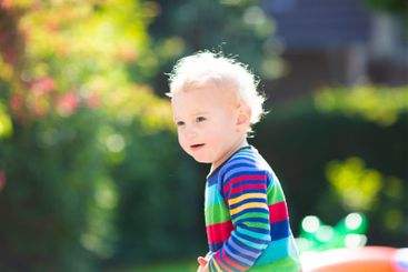 Baby boy in summer garden