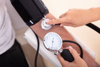 Doctor Measuring Blood Pressure Of Patient