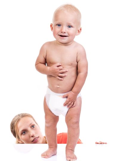 Mother watching her baby boy making first steps