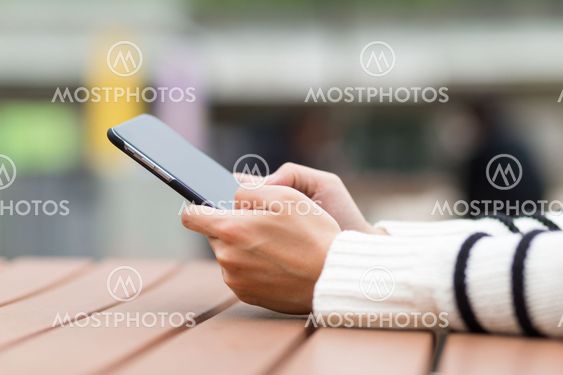 Woman use of mobile phone at outdoor cafe