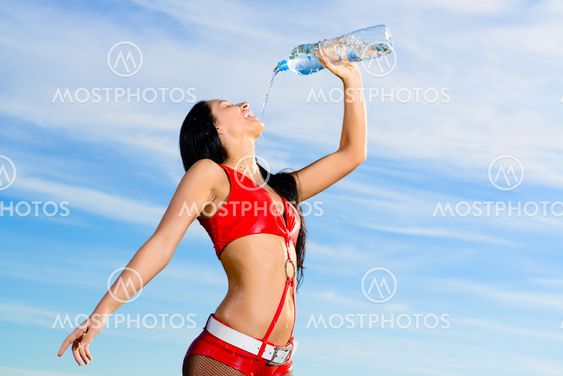 sport girl in red uniform with a bottle of water