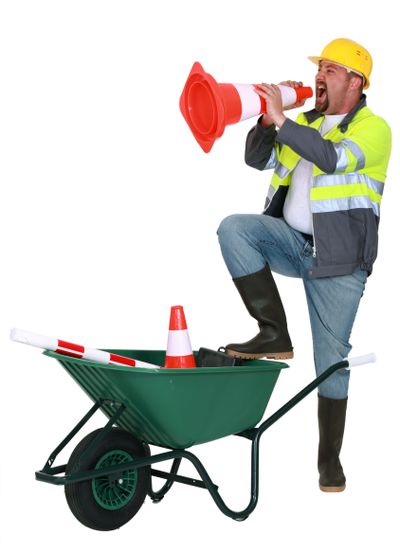 Laborer shouting into traffic cone