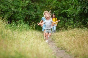 Kids, children running on green meadow, forest....
