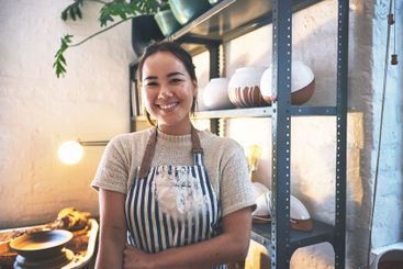 Workshop, woman and portrait with smile for pottery, art...