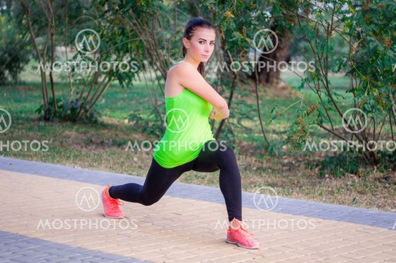 Young fitness girl does lunge exercises during workout