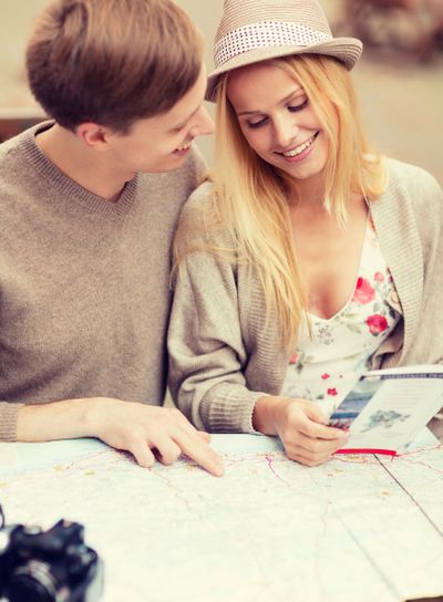 couple with map, camera and travellers guide