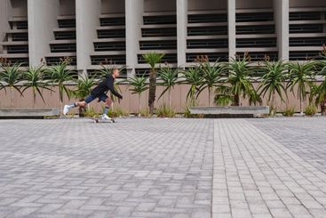 City, active and man with skateboard, practice and...