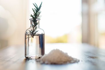 Water, rosemary and bath salt in bathroom for beauty,...