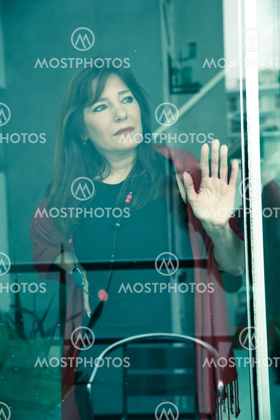 Mature woman looking out the window