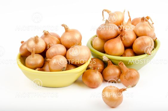 Two bowls full of onions on a white background