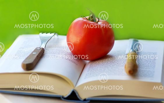 Red tomato on a book