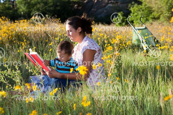 Young mother trying to study while taking care of her baby