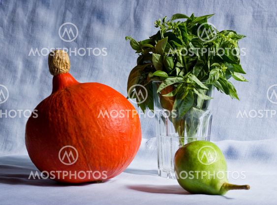 Still life of pumpkin, basil, pear