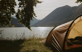 Tent by Lake Oppstryntvatn and mountain, Norway