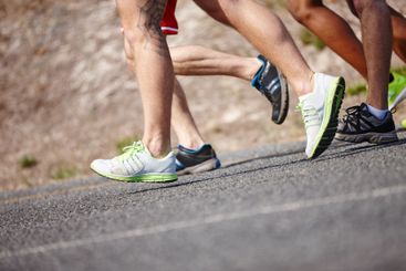 Shoes, legs and group running in road for marathon...